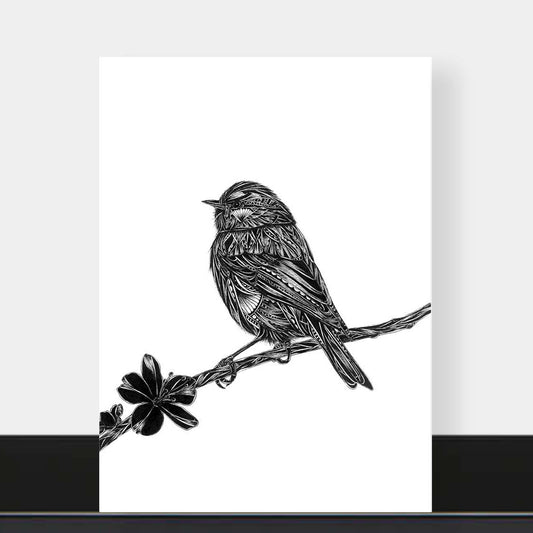 A vertical black and white art print featuring a detailed sketch of a bird perched on a branch with a flower, displayed against a light gray wall with a black baseboard.