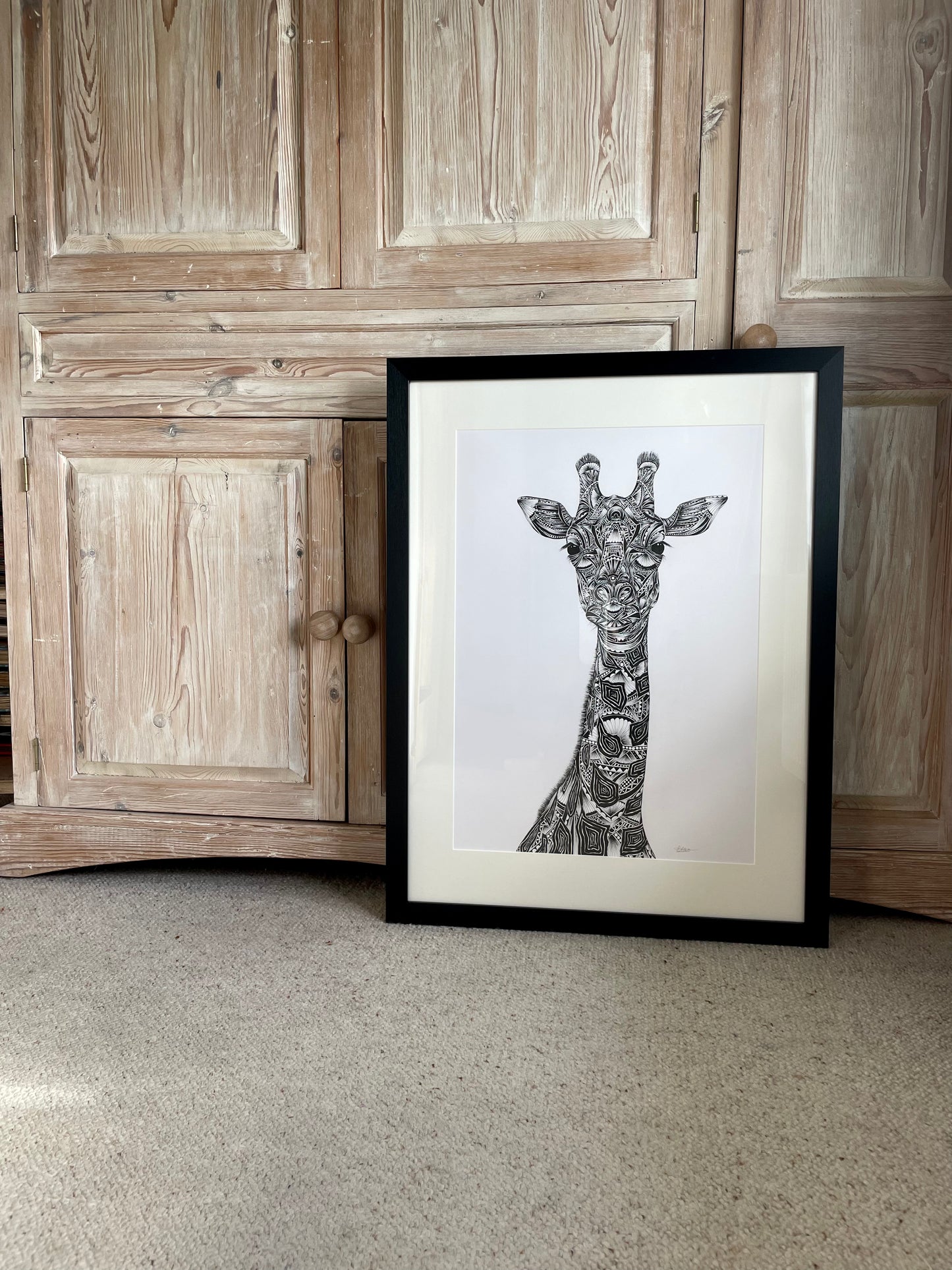 Monochrome giraffe original artwork in black frame, hand drawn in pen and ink by Pia Elliot in her Dorset studio