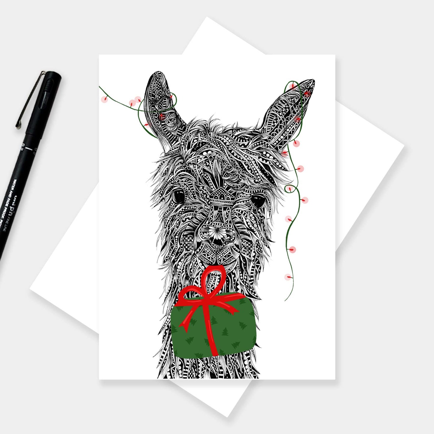 Whimsical llama Christmas greetings card originally hand drawn in pen and ink by Pia Elliot in her Dorset studio