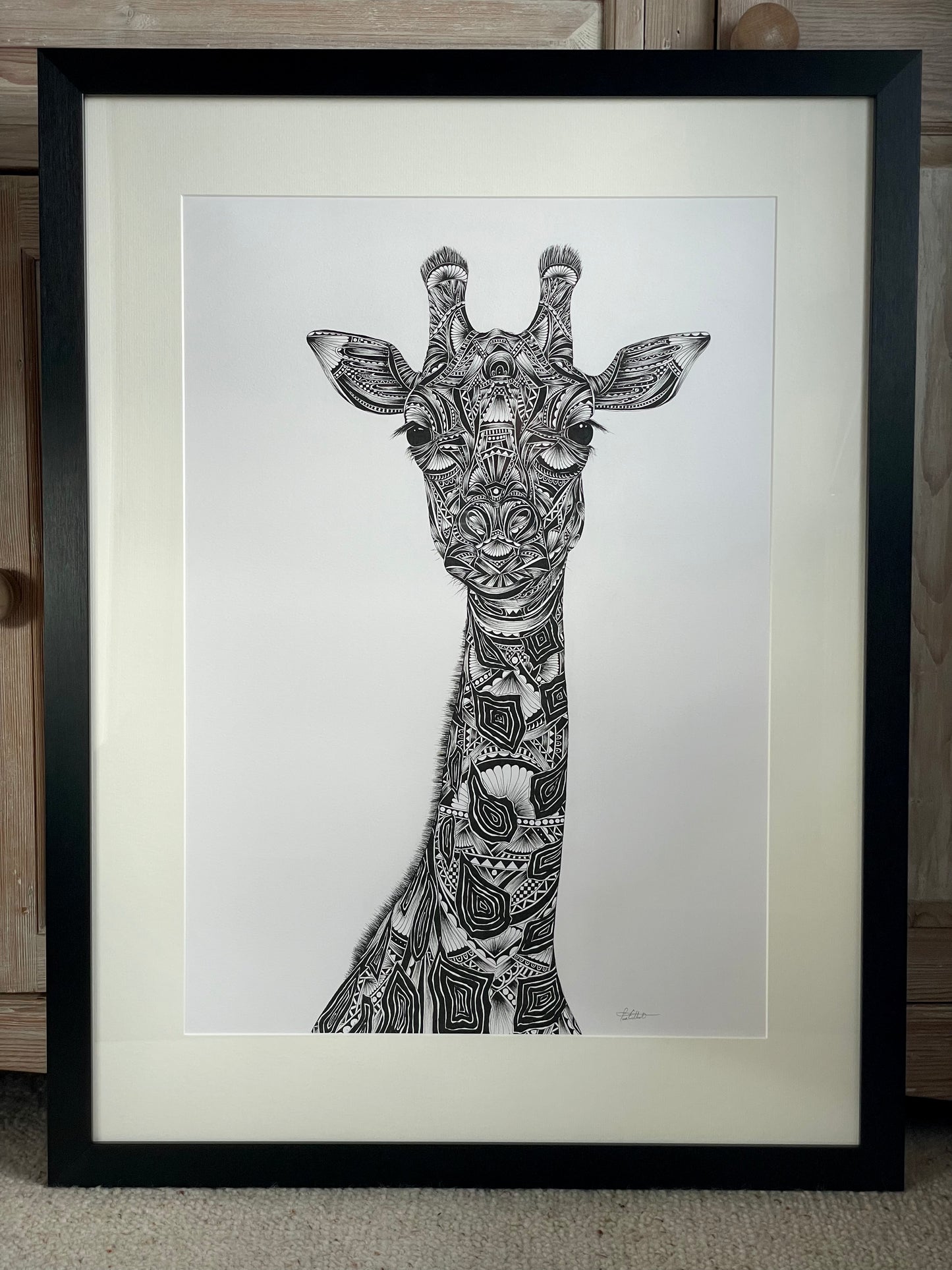 Monochrome giraffe original artwork in black frame, hand drawn in pen and ink by Pia Elliot in her Dorset studio