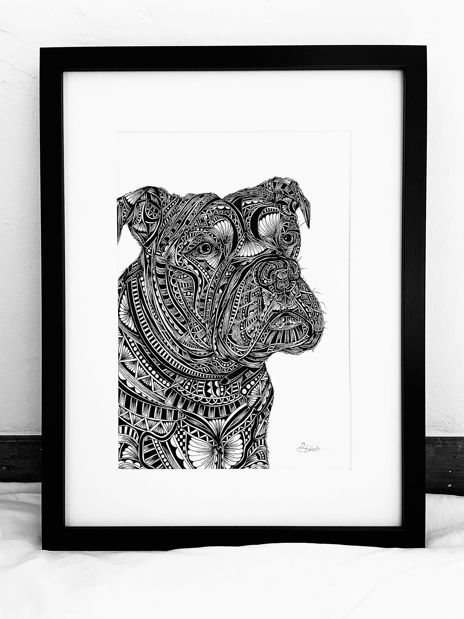 Framed black and white artwork of a dogs head on a white background