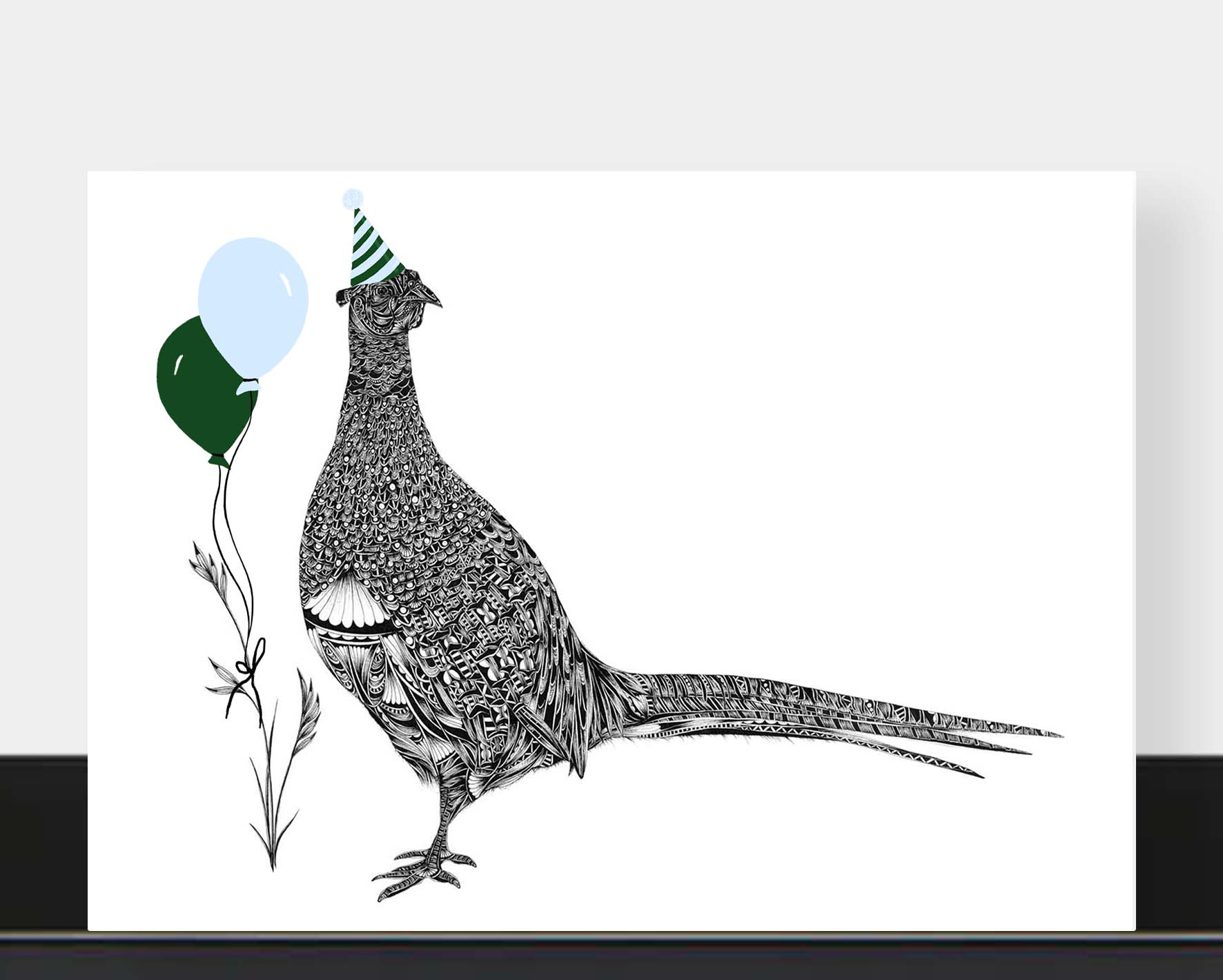 A horizontal greetings card featuring a detailed black-and-white illustration of a pheasant wearing a party hat, with two balloons in dark green and pale blue, shown against a white background.